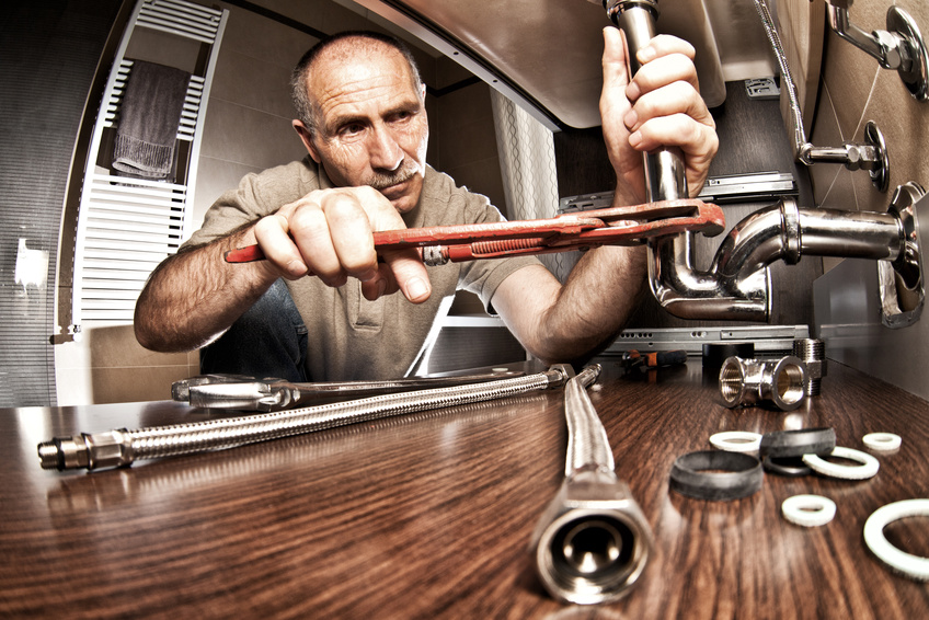 A plumber fixing pipes | Hire a Plumber